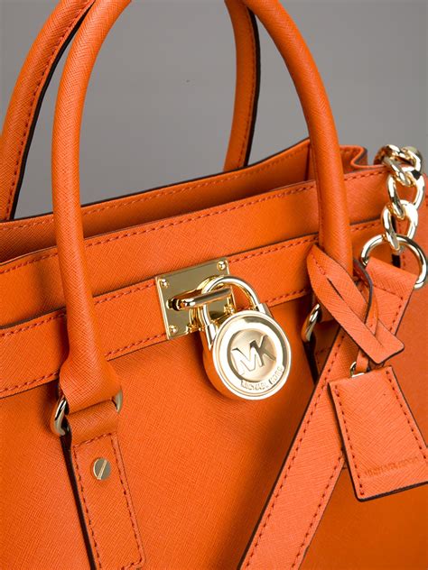 michael kors fringe tote|Michael Kors orange bag.